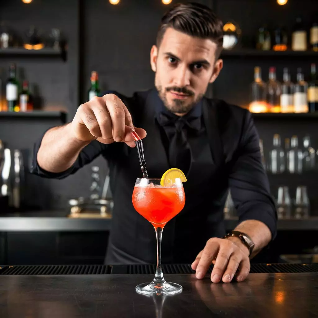 Современный бармен готовит коктейль Aperol в стильном баре